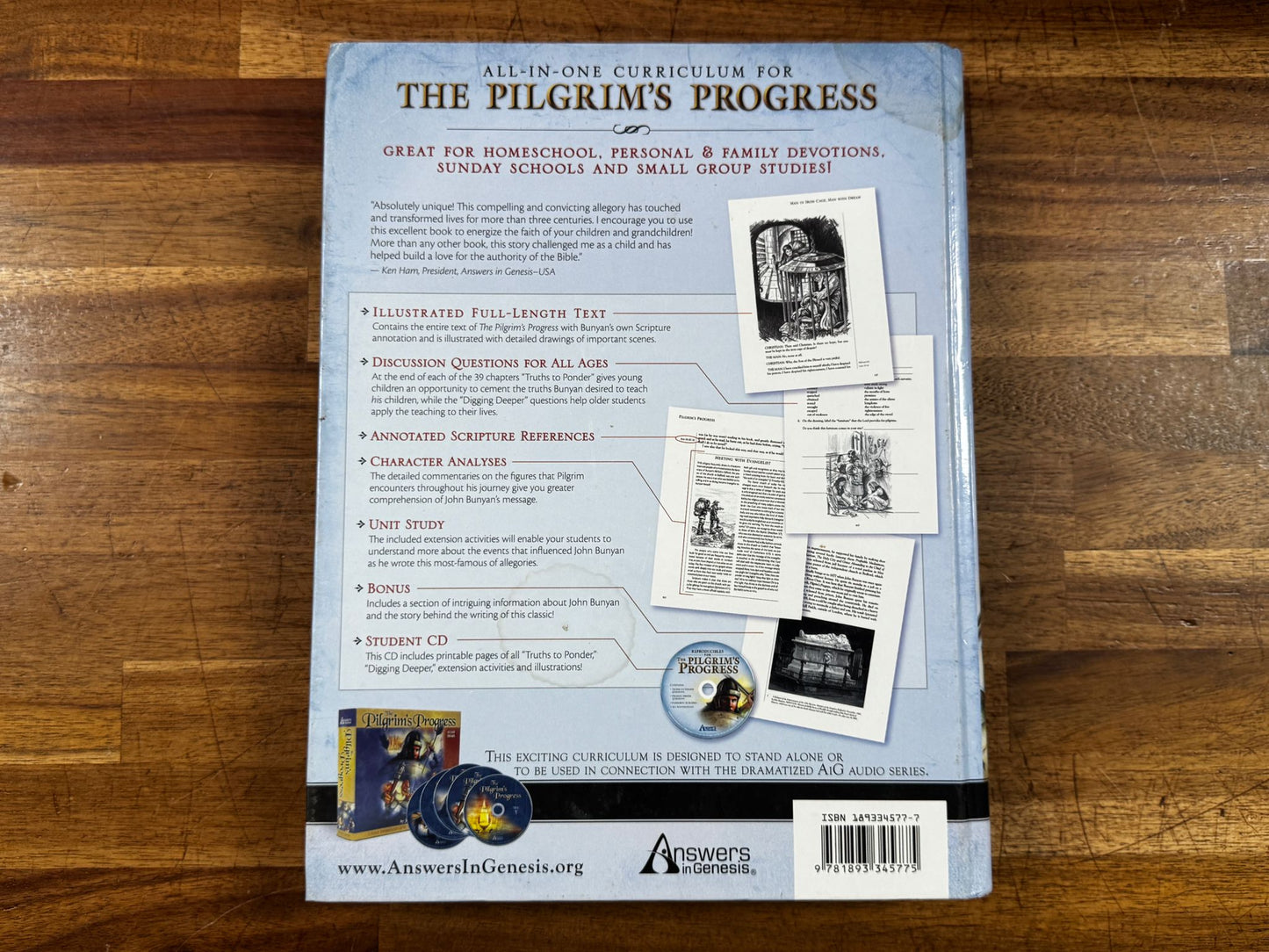 Back cover of a book titled 'The Pilgrim's Progress' on a wooden surface