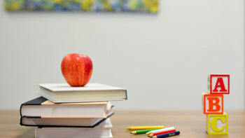 homeschool table with stacked books and a block