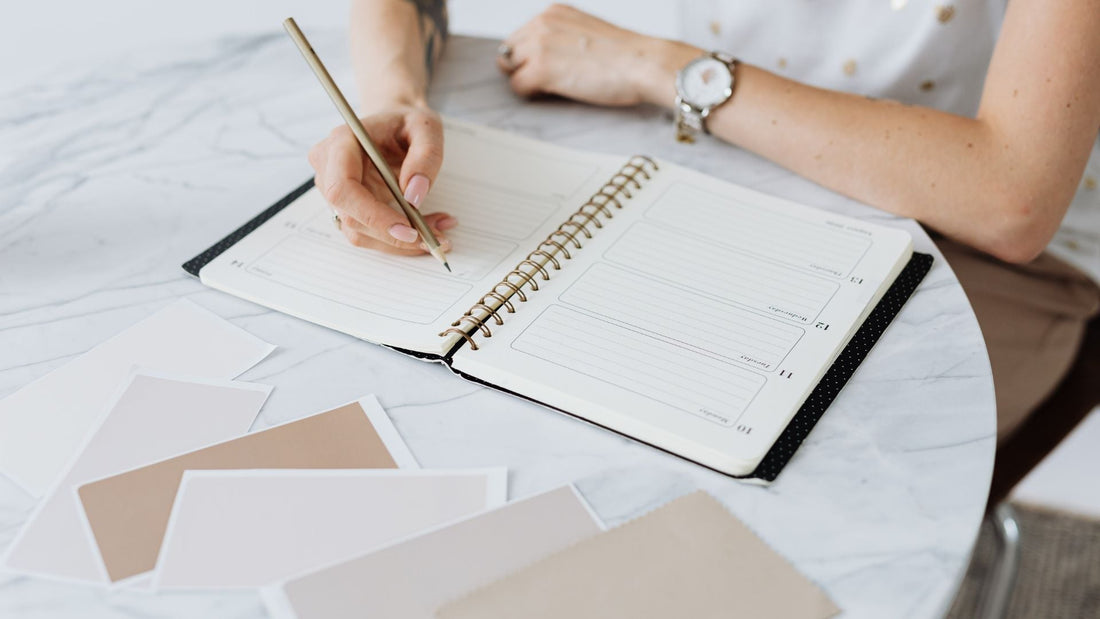person writing in planner