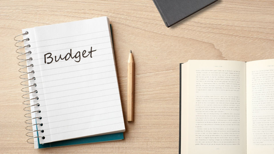 budget notebook with books and pencil
