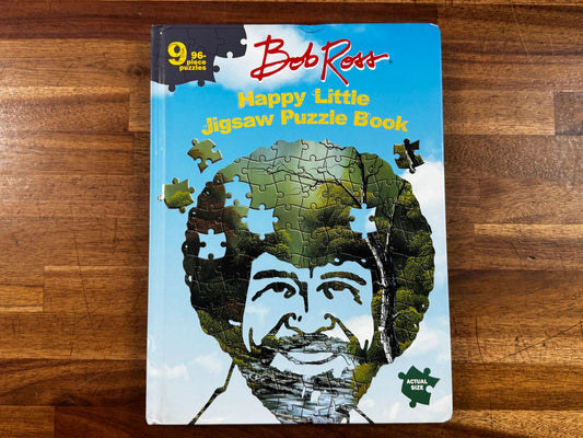 Jigsaw puzzle book with a face design on a wooden surface