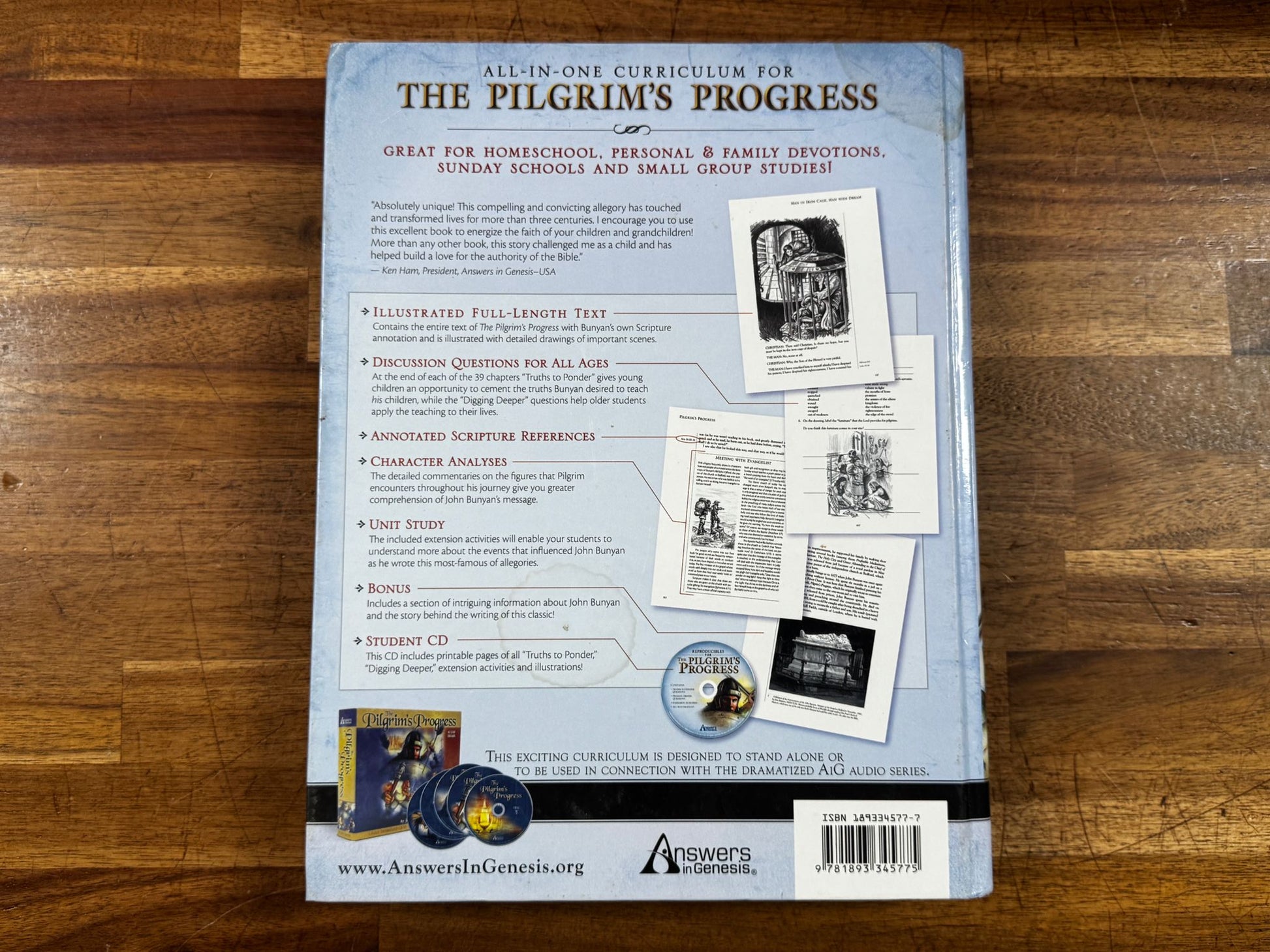 Back cover of a book titled 'The Pilgrim's Progress' on a wooden surface