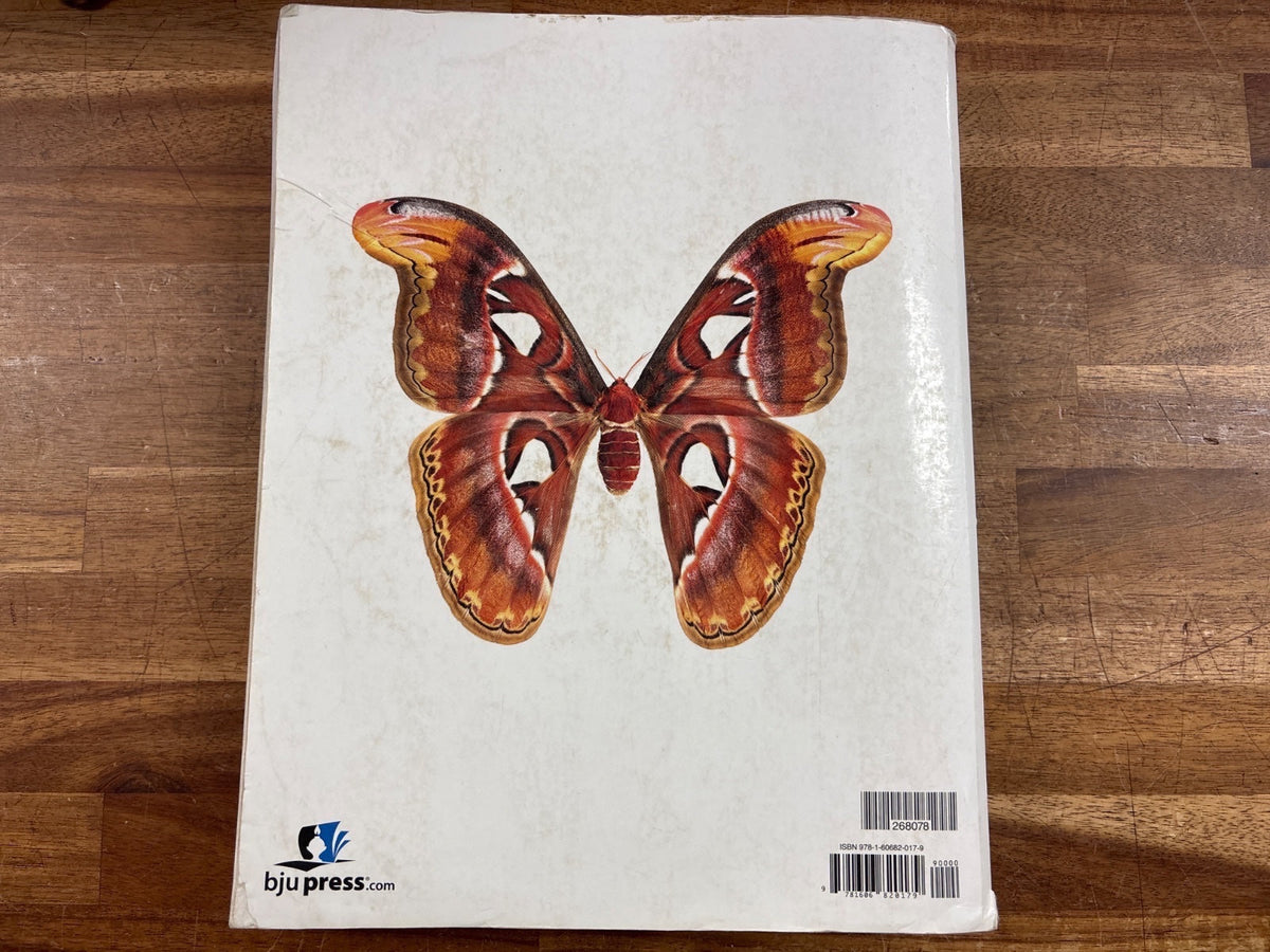 BJU Press Biology Fourth Edition Student Textbook — Acceptable — Item #268078 | Noticeable cover wear with a torn/damaged corner and some edge fraying; no writing inside visible. Highlighting on a few pages.